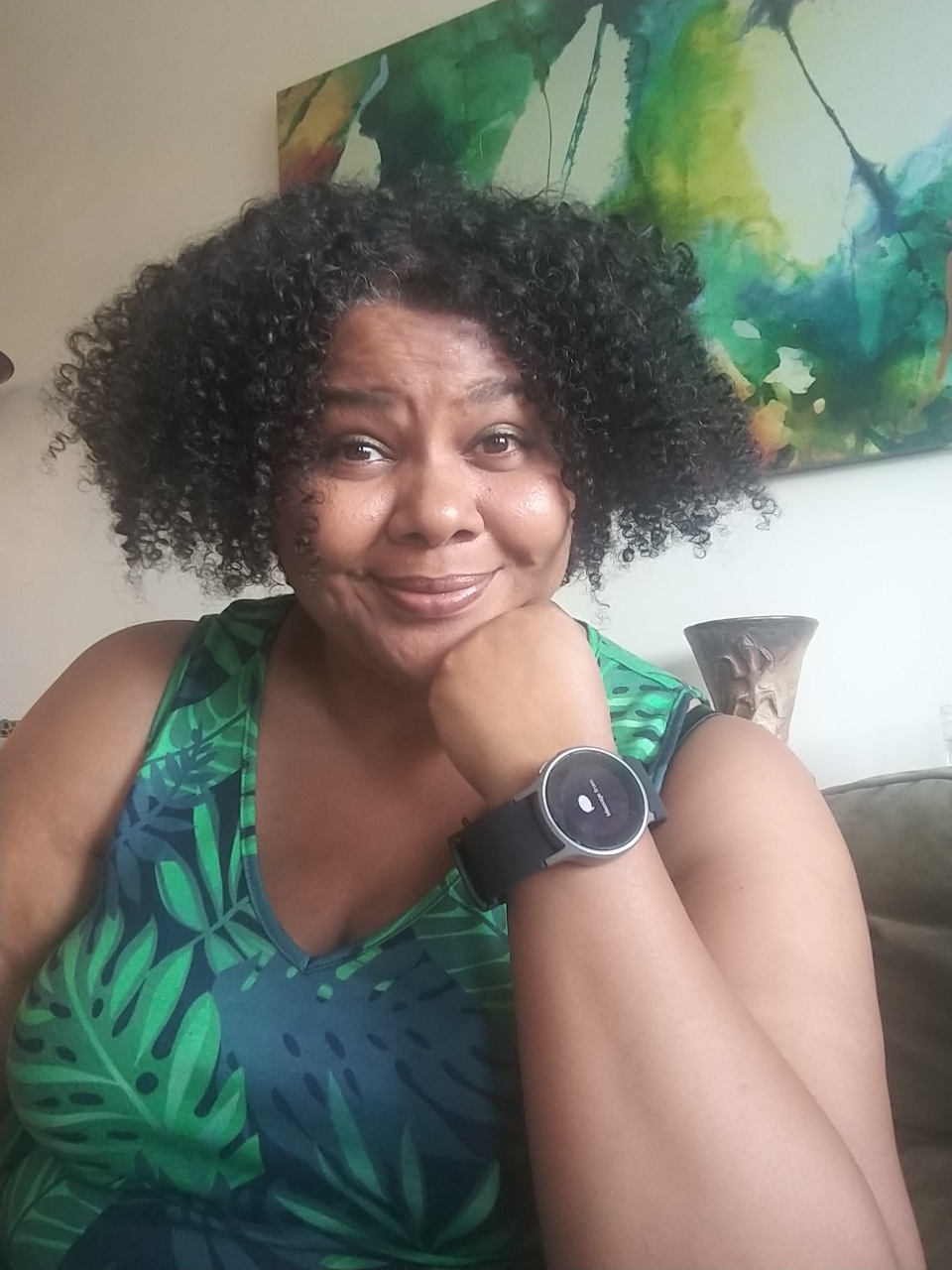 A Black woman with natural hair wearing a blood pressure smart watch